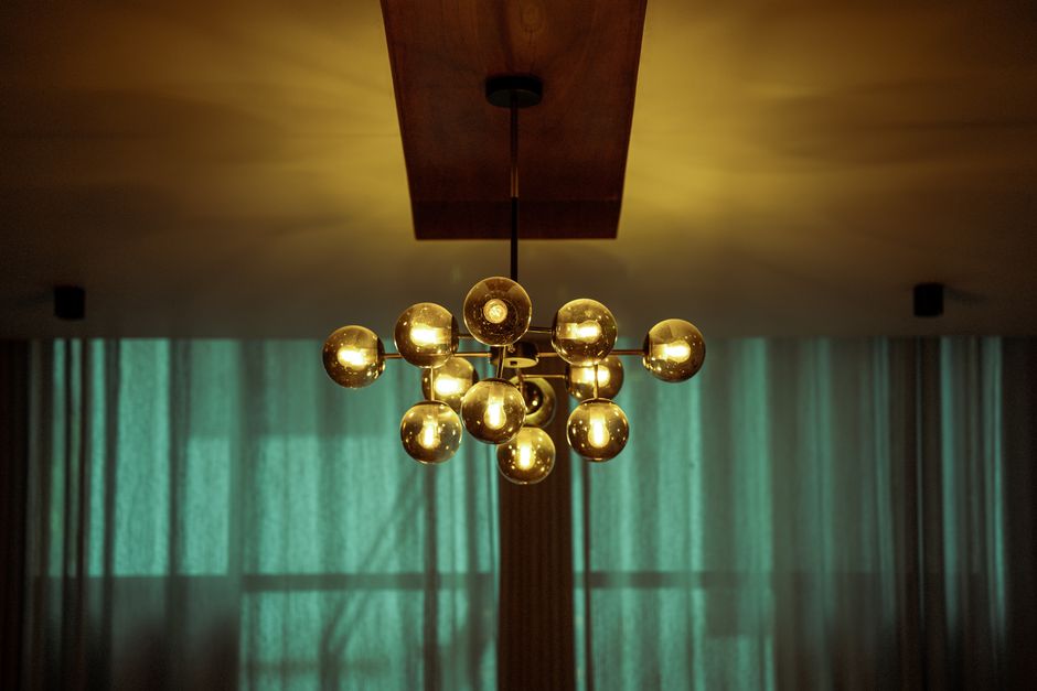A stylish modern chandelier with glowing bulbs, providing ambient indoor lighting.