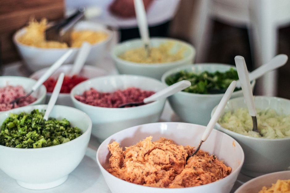 A vibrant selection of salad ingredients in bowls, perfect for a fresh, homemade meal.