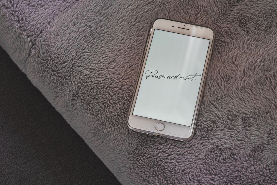 A smartphone on a plush surface with an inspirational message, ideal for motivational themes.