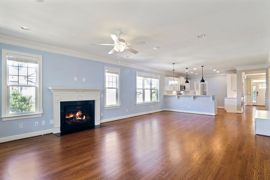 Spacious living room featuring a modern fireplace and wooden flooring, ideal for home decor inspiration.